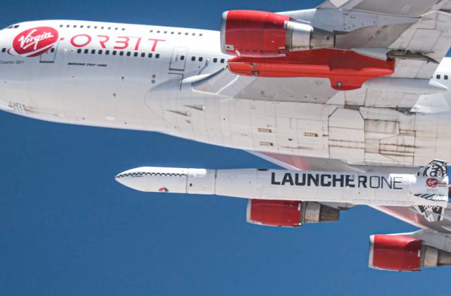 A photo of Virgin Orbit's carrier aircraft with a LauncherOne rocket attached to its belly.