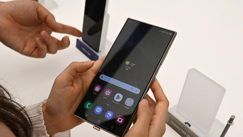 This picture taken on January 15, 2024 shows a woman looking at a Samsung Galaxy S24 Ultra smartphone displayed during a media preview event at a Samsung store in Seoul. (Photo by Jung Yeon-je / AFP) (Photo by JUNG YEON-JE/AFP via Getty Images)