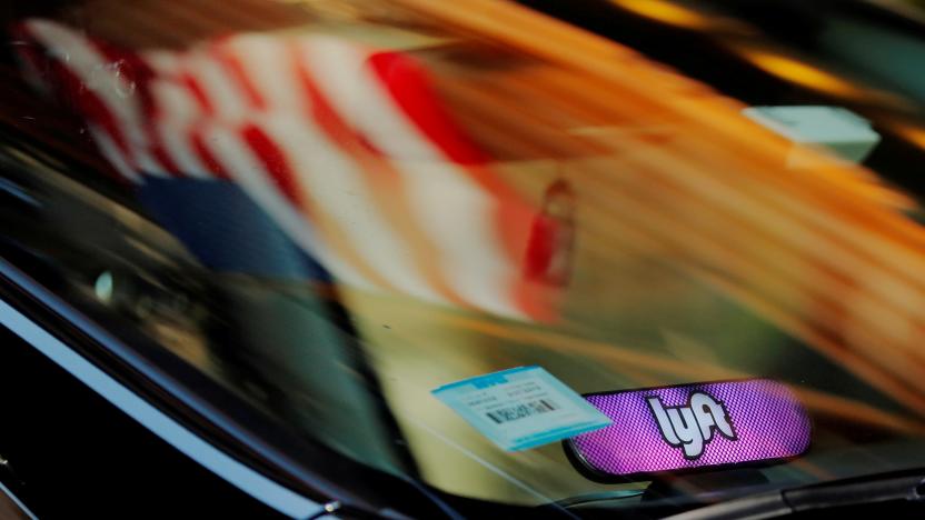 A car with a Lyft logo in its window drives down a street as the company prepares for its upcoming IPO in New York, U.S., March 19, 2019. REUTERS/Lucas Jackson TPX IMAGES OF THE DAY