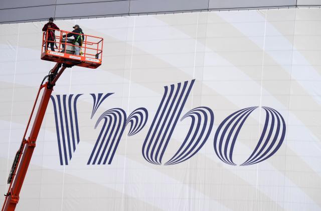 Dec 30, 2022; Glendale AZ, USA; Workers place Vrbo signage on the exterior of State Farm Stadium, the site of the 2022 CFP Semifinal between the TCU Horned Frogs and the Michigan Wolverines and Super Bowl 57 (LVII). Mandatory Credit: Kirby Lee-USA TODAY Sports