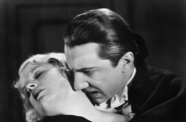 (Original Caption) Bela Lugosi, as Dracula, about to claim a beautiful victim in a scene from the famous movie.