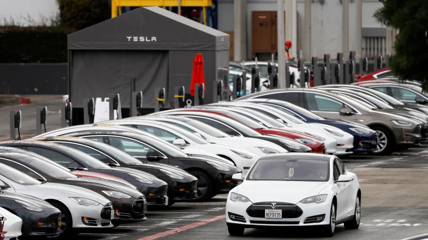 A Tesla Model S electric vehicle drives along a row of occupied superchargers at Tesla's primary vehicle factory after CEO Elon Musk announced he was defying local officials' restrictions against the coronavirus disease (COVID-19) by reopening the plant in Fremont, California, U.S. May 12, 2020. REUTERS/Stephen Lam