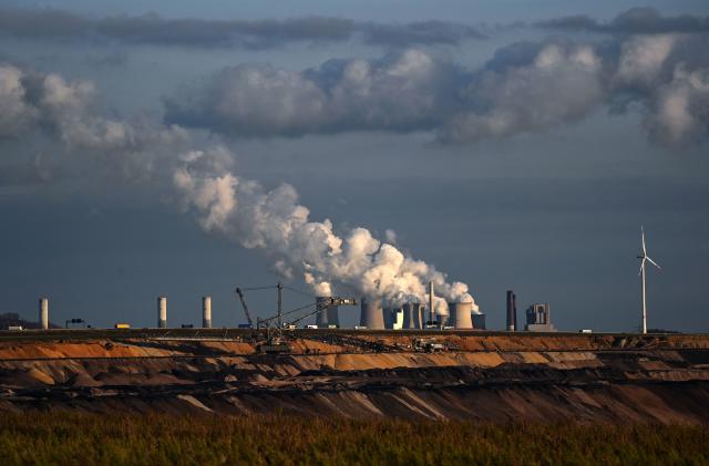 TOPSHOT - Open-cast lignite mining is seen near the coal-fired power station Neurath of German energy giant RWE in Garzweiler, western Germany, on October 27, 2021. - From October 31 to November 12, the 26th World Climate Conference (COP26) will take place in Glasgow, Scotland. Delegates from all over the world will meet there with the aim of pushing ahead more strongly with measures to combat the climate crisis. (Photo by Ina FASSBENDER / AFP) (Photo by INA FASSBENDER/AFP via Getty Images)