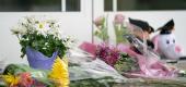 Flowers and stuffed animals sit outside of Riverview Family Medicine and Urgent Care after the shooting. (Getty Images)