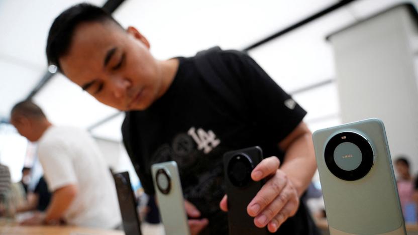 A man checks Huawei's Mate 60 series smartphones displayed at a Huawei store in Shanghai, China September 8, 2023. 