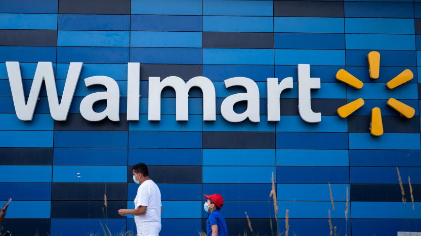 A man and child wearing facemasks walk in front of a Walmart store in Washington, DC on July 15, 2020. - Walmart will require shoppers to wear face masks starting next week, the US retail giant announced on July 15, joining an increasing number of businesses in mandating the protection amid the latest spike in coronavirus cases. (Photo by ANDREW CABALLERO-REYNOLDS / AFP) (Photo by ANDREW CABALLERO-REYNOLDS/AFP via Getty Images)