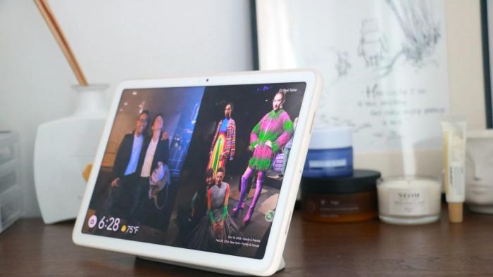 A tablet on top of a wooden table.