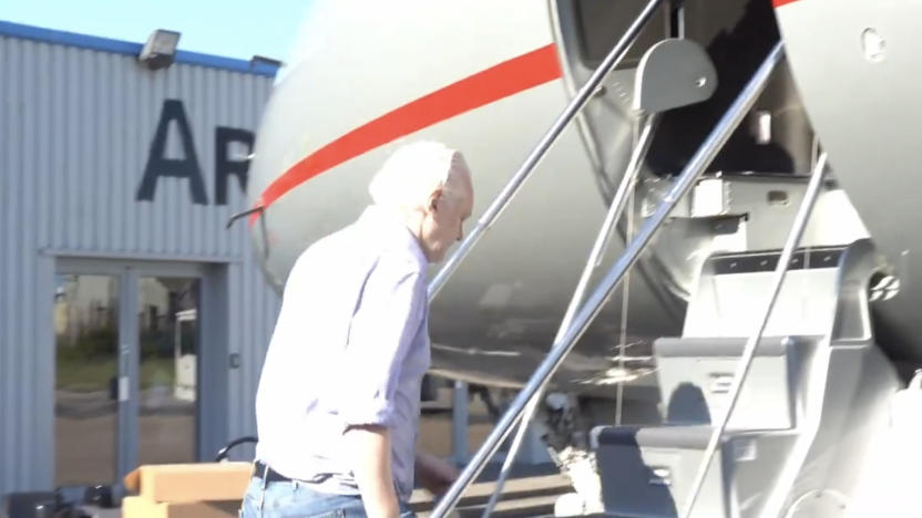 A man climbing the steps to a plane.