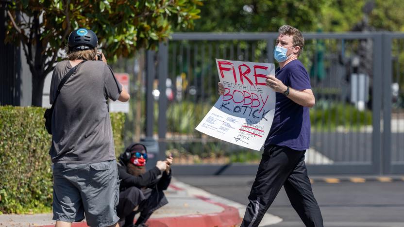 A man carrying a sign accusing Activision Blizzard CEO Robert A. Kotick of pedophilia is ordered by protest organizers to leave the area as employees of the video game holding company, Activision Blizzard, hold a walkout and protest rally to denounce the companys response to a California Department of Fair Employment and Housing lawsuit and to call for changes in conditions for women and other marginalized groups, in Irvine, California, on July 28, 2021.  (Photo by DAVID MCNEW / AFP) (Photo by DAVID MCNEW/AFP via Getty Images)