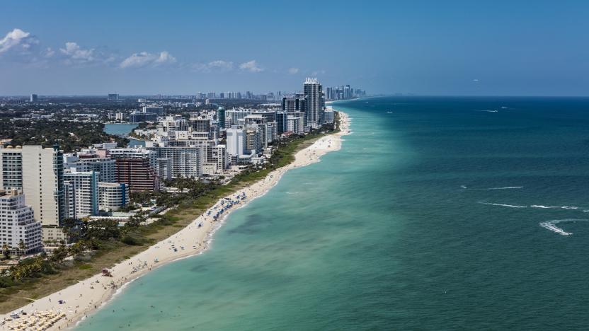 Aerial view of South Beach Miami Florida cityscape with buildings along the beach on a beautiful sunny day, people on beach and ocean