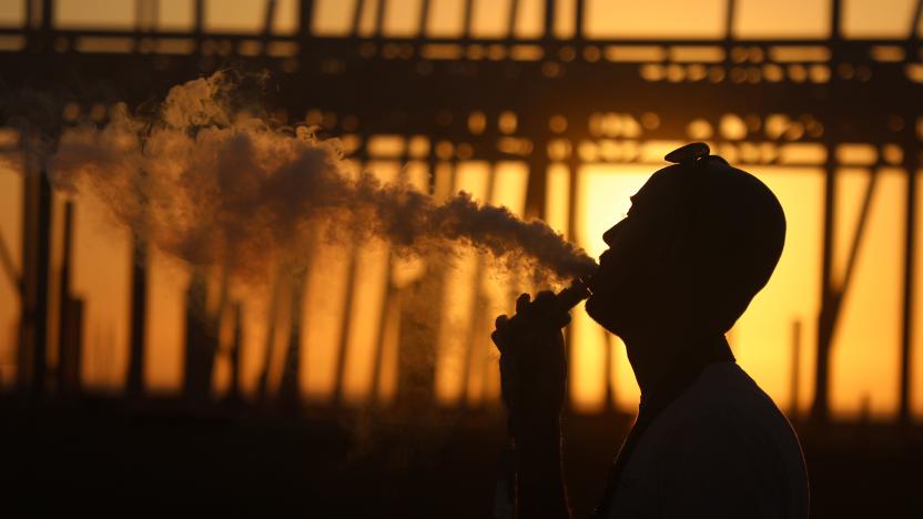 Young woman vaping as the national lockdown ends and the new three tier system of local coronavirus restrictions begins, shoppers head out to Oxford Street to catch up on shopping as non-essential shops are allowed to reopen on 2nd December 2020 in London, United Kingdom. Many shoppers wear face masks outside on the street as a precaution as there are so many people around. (photo by Mike Kemp/In Pictures via Getty Images)