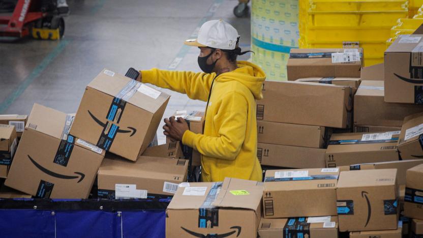 An employee scans packages at Amazon's JFK8 distribution center in Staten Island, New York, U.S. November 25, 2020.  REUTERS/Brendan McDermid.