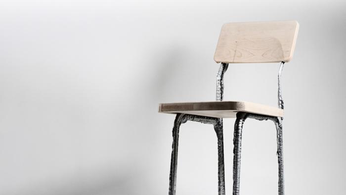 A wood chair with 3D-printed chair legs. 