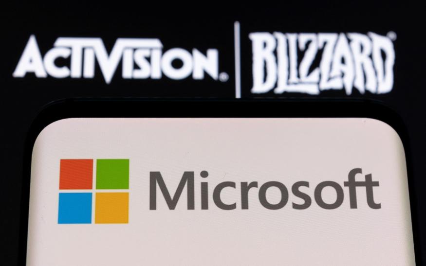 Microsoft logo is seen on a smartphone placed on displayed Activision Blizzard logo in this illustration taken January 18, 2022. REUTERS/Dado Ruvic/Illustration
