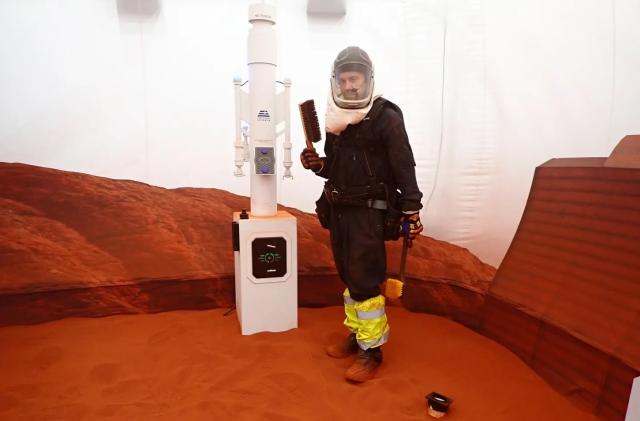 Nathan Jones stands inside the simulated Mars environment in a 1200-square-foot sandbox attached to the 3D printed habitat