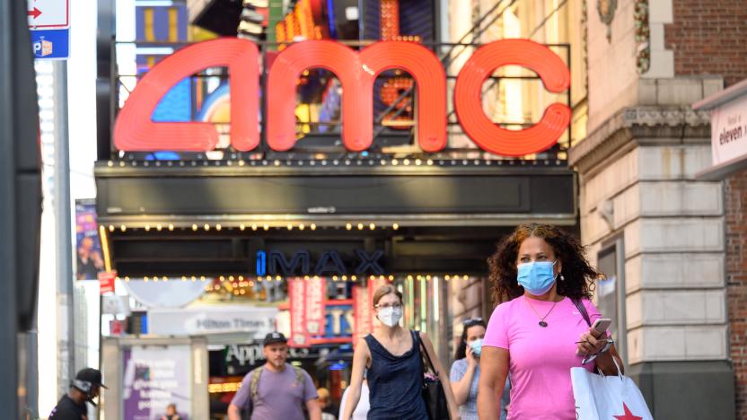 NEW YORK, NEW YORK - AUGUST 05: People wear protective face masks outside the AMC Empire 25 movie theater in Times Square as the city continues Phase 4 of re-opening following restrictions imposed to slow the spread of coronavirus on August 5, 2020 in New York City. The fourth phase allows outdoor arts and entertainment, sporting events without fans and media production. (Photo by Noam Galai/Getty Images)
