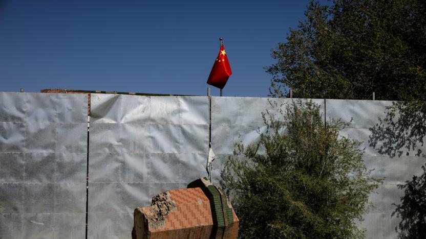 A broken-off minaret of Xinqu Mosque lies near a Chinese national flag near the house of worship in Changji outside Urumqi, Xinjiang Uyghur Autonomous Region, China, May 6, 2021. Picture taken May 6, 2021. REUTERS/Thomas Peter  SEARCH "XINJIANG PETER" FOR THIS STORY. SEARCH "WIDER IMAGE" FOR ALL STORIES. TPX IMAGES OF THE DAY.