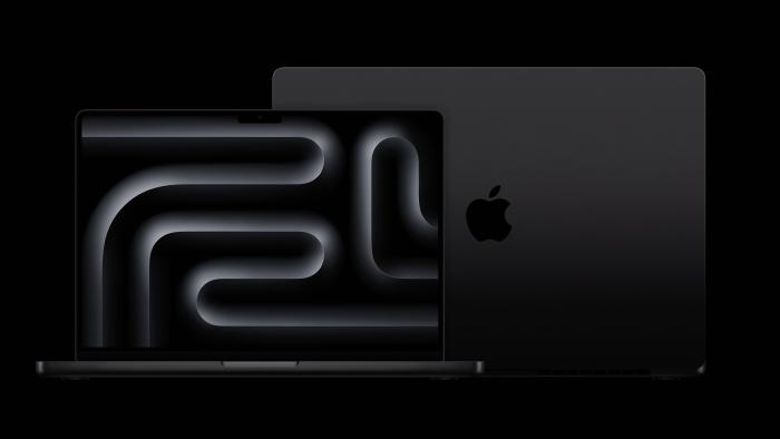 MacBook Pro in Space Black against a black background