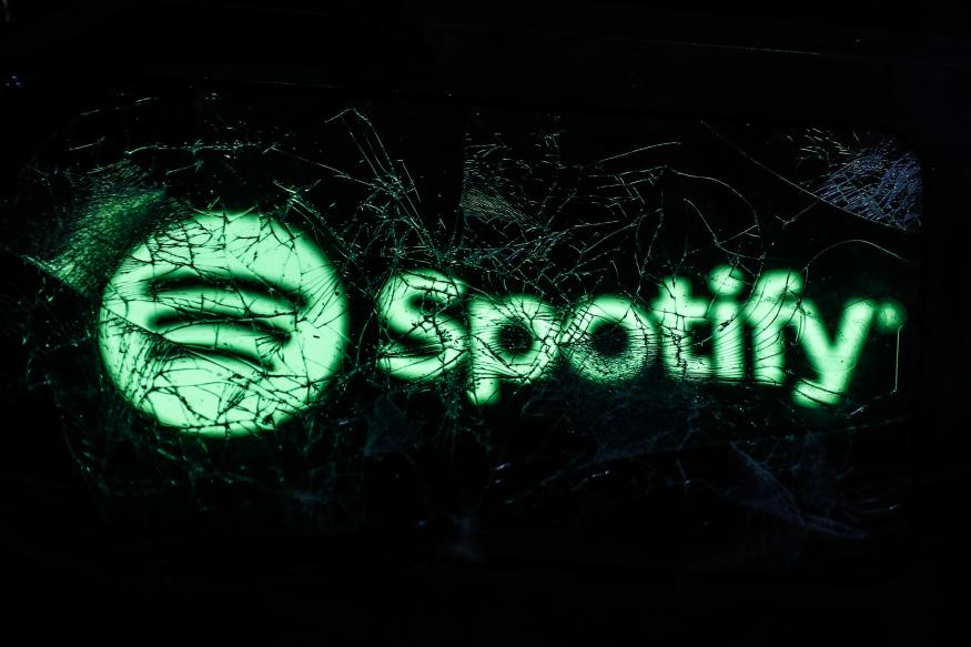 Spotify logo displayed on a phone screen is seen through a broken glass in this illustration photo taken in Krakow, Poland on February 14, 2022. (Photo by Jakub Porzycki/NurPhoto via Getty Images)