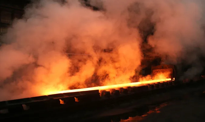 Steam rolls off a slab of steel as it rolls down the line at the Novolipetsk Steel PAO steel mill in Farrell, Pennsylvania, U.S., March 9, 2018. REUTERS/Aaron Josefczyk