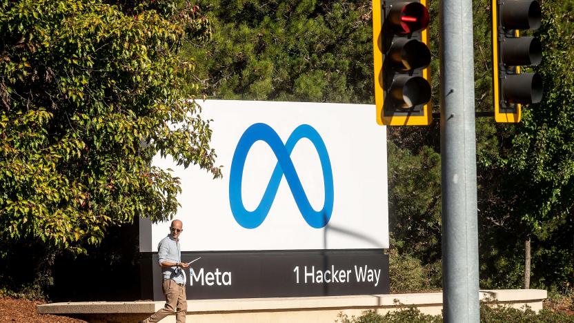 A man passes a newly unveiled logo for "Meta", the new name for Facebook's parent company, outside Facebook headquarters in Menlo Park on October 28, 2021. - Facebook changed its parent company name to "Meta" on October 28 as the tech giant tries to move past being a scandal-plagued social network to its virtual reality vision for the future. (Photo by NOAH BERGER / AFP) (Photo by NOAH BERGER/AFP via Getty Images)