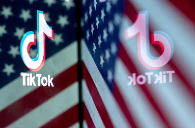 This photo illustration shows the TikTok logo reflected in an image of the US flag, in Washington, DC, on March 16, 2023. - China urged the United States to stop "unreasonably suppressing" TikTok on March 16, 2023, after Washington gave the popular video-sharing app an ultimatum to part ways with its Chinese owners or face a nationwide ban. (Photo by Stefani Reynolds / AFP) (Photo by STEFANI REYNOLDS/AFP via Getty Images)