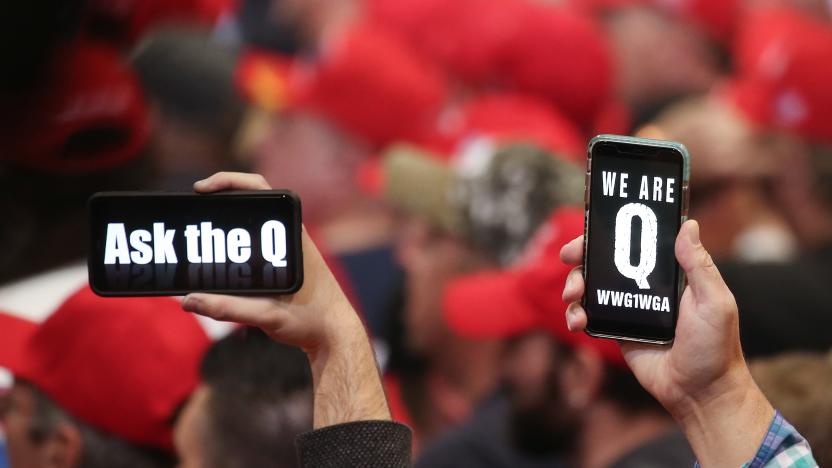 LAS VEGAS, NEVADA - FEBRUARY 21: Supporters of President Donald Trump hold up their phones with messages referring to the QAnon conspiracy theory at a campaign rally at Las Vegas Convention Center on February 21, 2020 in Las Vegas, Nevada. The upcoming Nevada Democratic presidential caucus will be held February 22. (Photo by Mario Tama/Getty Images)