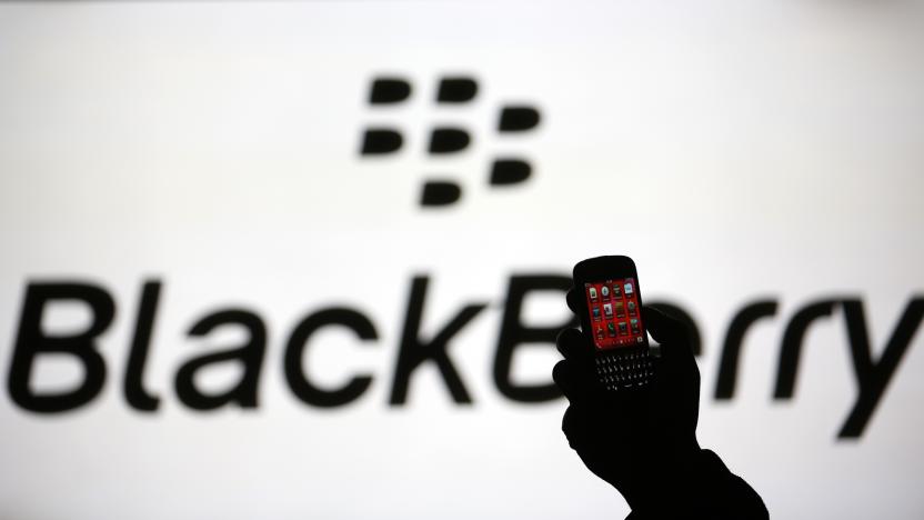 A man is silhouetted against a video screen with the Blackberry logo as he pose with a Blackberry Q10 in this photo illustration taken in the central Bosnian town of Zenica, September 21, 2013. BlackBerry Ltd warned on Friday it expects to report a huge quarterly operating loss next week and that it will cut more than a third of its global workforce, rekindling fears of the company's demise and sending its shares into a tailspin.The company, which has struggled to claw back market share from the likes of Apple Inc's  iPhone and Samsung Electronics Co Ltd's Galaxy phones, said it expects to report a net operating loss of between $950 million and $995 million in the quarter ended Aug. 31, due to writedowns and other factors.   REUTERS/Dado Ruvic (BOSNIA AND HERZEGOVINA - Tags: BUSINESS TELECOMS)