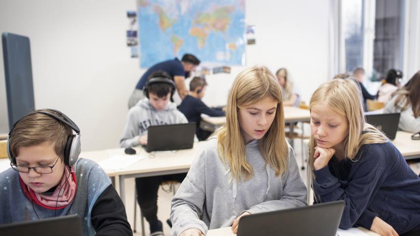 Children in classroom using laptops