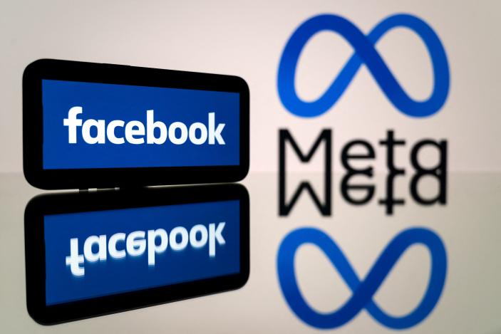 This picture taken on January 12, 2023 in Toulouse, southwestern France shows a smartphone and a computer screen displaying the logos of the social network Facebook and its parent company Meta. (Photo by Lionel BONAVENTURE / AFP) (Photo by LIONEL BONAVENTURE/AFP via Getty Images)