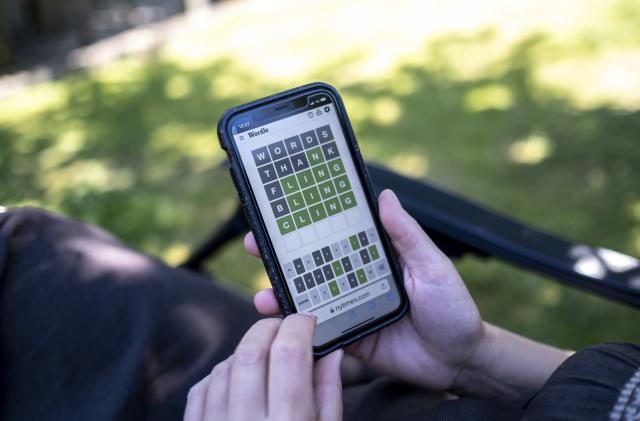 Woman plays Wordle on her smartphone from a seat in a garden and struggling to complete the last word on 10th August 2022 in St Dogmaels, Wales, United Kingdom. Wordle is a web-based word game played by millions of users / players worldwide often on their mobile devices. The game was created and developed by software engineer Josh Wardle, and owned by The New York Times Company since 2022. (photo by Mike Kemp/In Pictures via Getty Images)