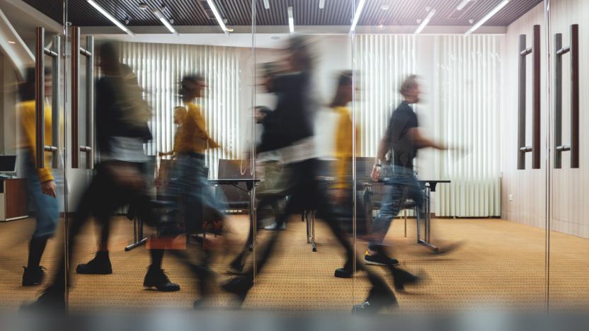 Businesspeople walking at modern office. Group of business employees at coworking center. Motion blur. Concept work process. Wide image