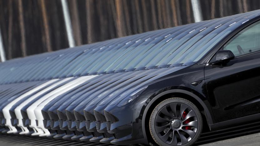 File - Tesla cars are parked at the construction site of the new Tesla Gigafactory for electric cars in Gruenheide near Berlin, Germany, March 18, 2022. Tesla is expected to report fourth quarter and full year sales Tuesday as electric vehicle sales growth continues to slow. (AP Photo/Michael Sohn, File)