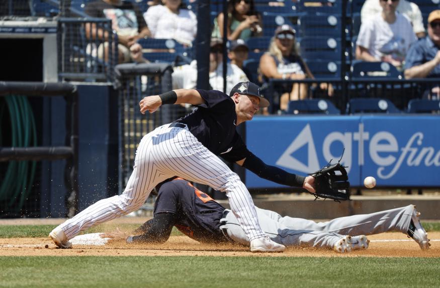 Apr 5, 2022; Tampa, Florida, USA; Detroit Tigers center fielder Victor Reyes (22) slides safe into third base as New York Yankees third baseman Josh Donaldson (28) attempted to tag him out during the fourth inning during spring training at George M. Steinbrenner Field. Mandatory Credit: Kim Klement-USA TODAY Sports