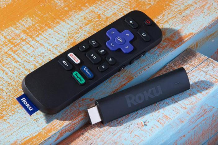 A streaming stick and a remote on a table.