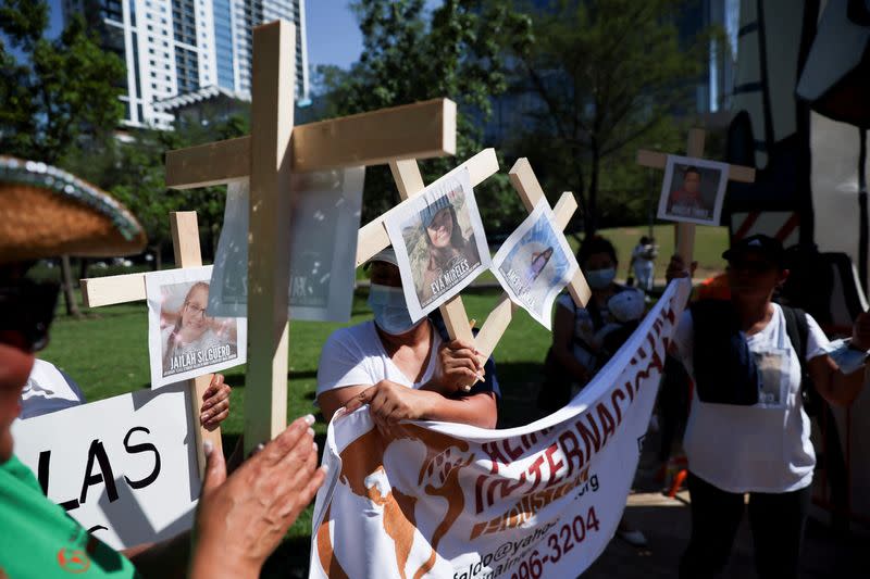 Protesters holding photos of shooting victims gather outside NRA convention in Texas