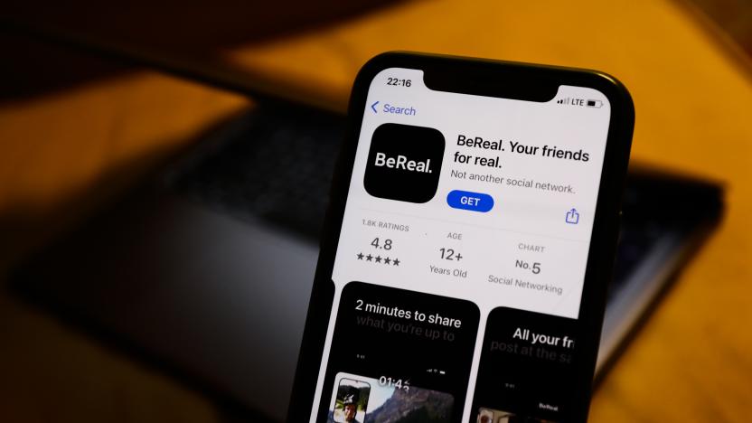 BeReal on the App Store displayed on a phone screen and a laptop in the background are seen in this illustration photo taken in Poland on August 7, 2022. (Photo by Jakub Porzycki/NurPhoto via Getty Images)