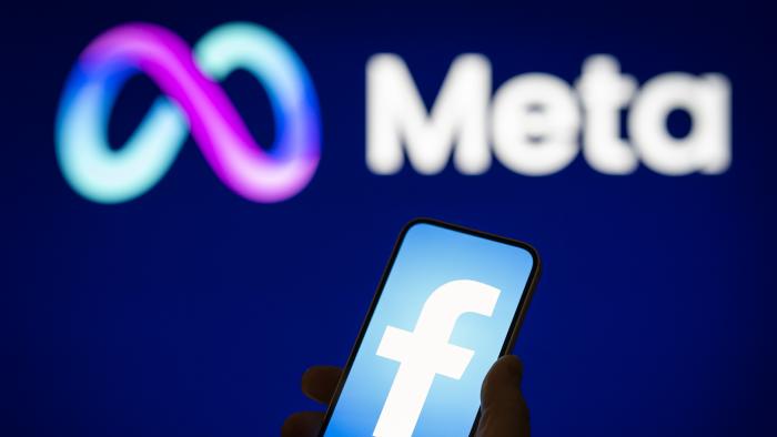 A Facebook logo is seen on a mobile device screen with a Meta logo in the background in this photo illustration on 31 May, 2023 in Warsaw, Poland. (Photo by Jaap Arriens/NurPhoto via Getty Images)