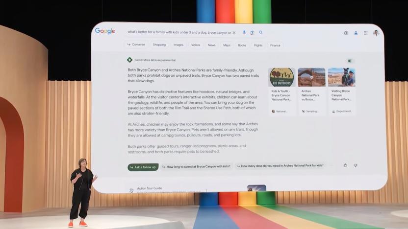 Still from Google's 2023 I/O presentation on SGE. A presenter stands on the stage with a huge slide behind her showing AI-generated results in Google search.