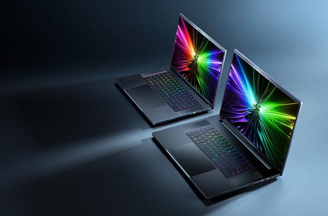 Marketing photo for the Razer Blade 16 and 18. The laptops sit next to each other on a blue surface with dramatic shadows. View from above and to their right. The laptops are open with colorful images on their screens.