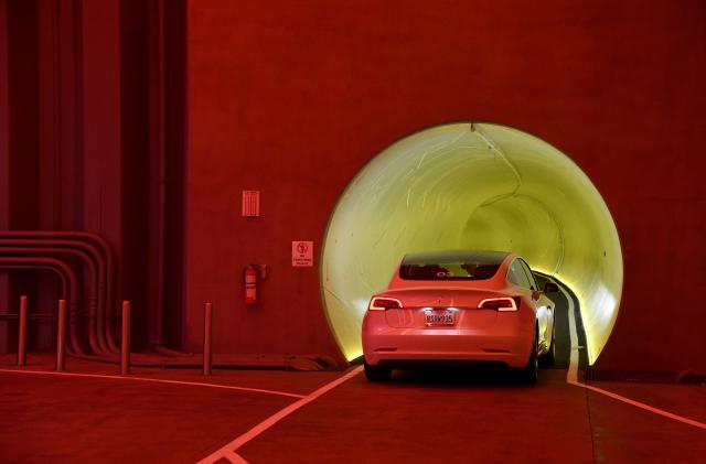 LAS VEGAS, NEVADA - APRIL 09:  A Tesla car drives through a tunnel in the Central Station during a media preview of the Las Vegas Convention Center Loop on April 9, 2021 in Las Vegas, Nevada. The Las Vegas Convention Center Loop is an underground transportation system that is the first commercial project by Elon Musk’s The Boring Company. The USD 52.5 million loop, which includes two one-way vehicle tunnels 40 feet beneath the ground and three passenger stations, will take convention attendees across the 200-acre convention campus for free in all-electric Tesla vehicles in under two minutes. To walk that distance can take upward of 25 minutes. The system is designed to carry 4,400 people per hour using a fleet of 62 vehicles at maximum capacity. It is scheduled to be fully operational in June when the facility plans to host its first large-scale convention since the COVID-19 shutdown. There are plans to expand the system throughout the resort corridor in the future.  (Photo by Ethan Miller/Getty Images)