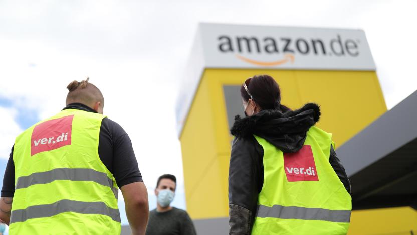 KOBERN-GONDORF, GERMANY - JUNE 29: Striking Amazon employees stand outside an Amazon warehouse during the coronavirus pandemic on June 29, 2020 in Kobern-Gondorf near Koblenz, Germany. The Verdi labor union has called for strikes at six Amazon warehouse across Germany in order to put pressure on the company over an ongoing disagreement over pay as well as improving workplace conditions to help prevent outbreaks of the coronavirus. Approximately 40 Amazon employees tested positive recently for Covid-19 infection at an Amazon warehouse in Bad Hersfeld. (Photo by Andreas Rentz/Getty Images)