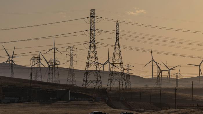 A view of windmills and power lines, as California's grid operator urged the state's 40 million people to ratchet down the use of electricity in homes and businesses as a wave of extreme heat settled over much of the state, near Tracy, California, U.S., August 17, 2022. REUTERS/Carlos Barria