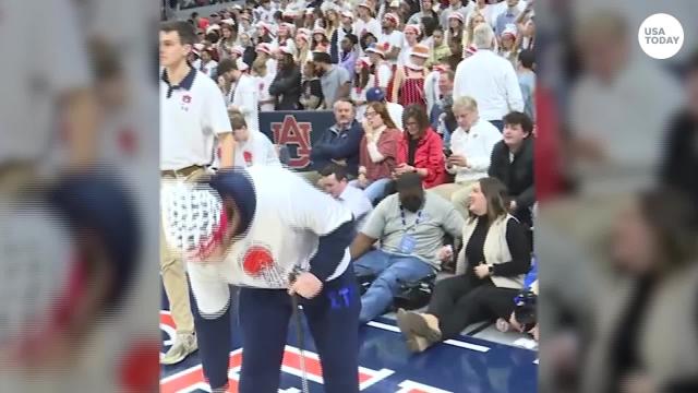 And the crowd goes wild! College student wins new car after precise 94 foot golf shot.