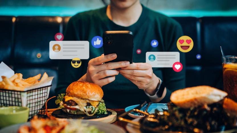 Cropped shot of young Asian woman using smartphone on social media app during meal in restaurant. Viewing posts, giving like, love, comment, making friends on pages in the city. People engaging in networking with technology. Social media addiction concept