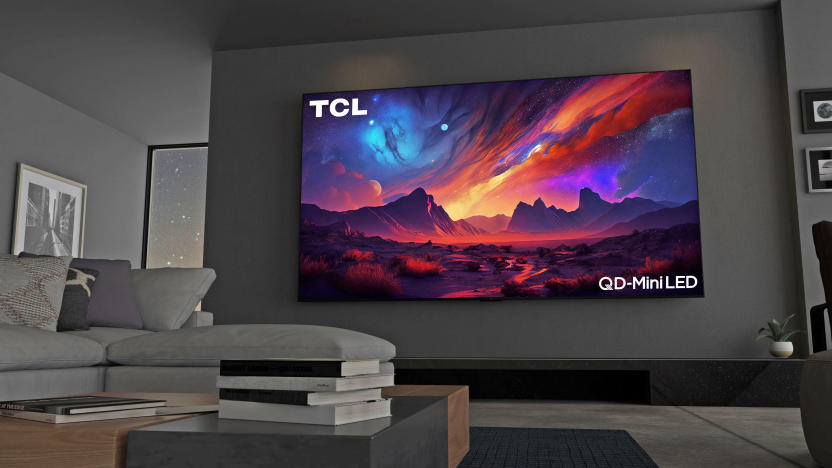A couch point-of-view of the TCL 115QM89 115-inch MiniLED Quantum Dot TV installed on a wall in a living room.