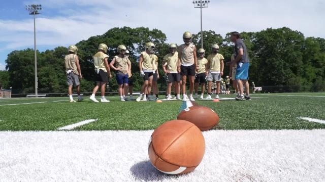 Players and Coaches Hit the Field for the First day of Football Practice