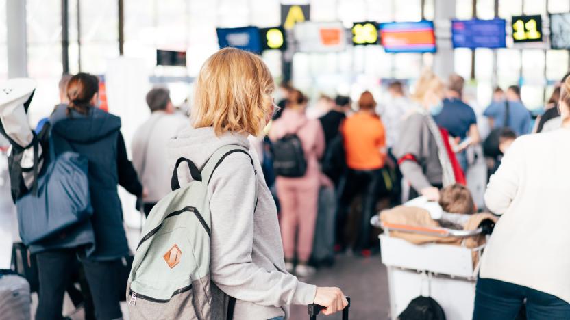 Unrecognizable people, a view from the back, a queue at the airport for check-in.