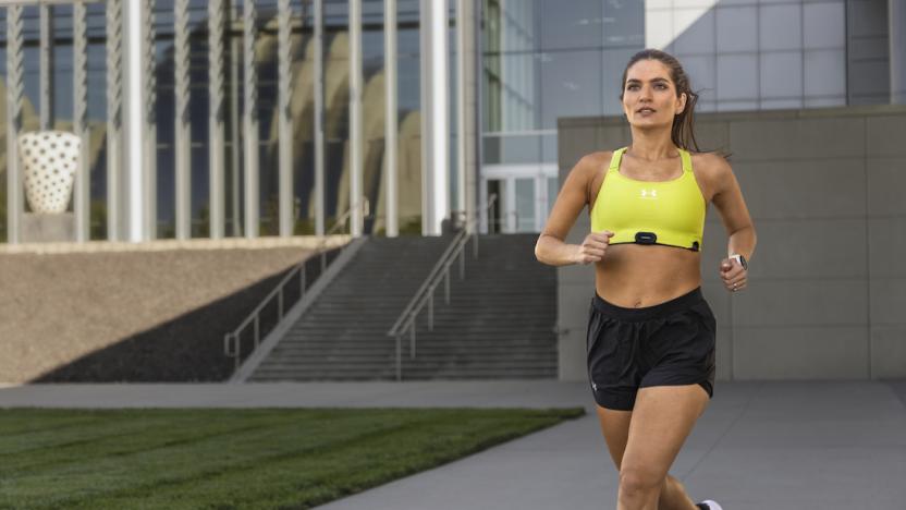 A person runs with the HRM-Fit attached to their sports bra. 