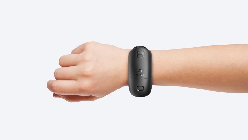 A person's arm wearing an HTC Vive Wrist Tracker.